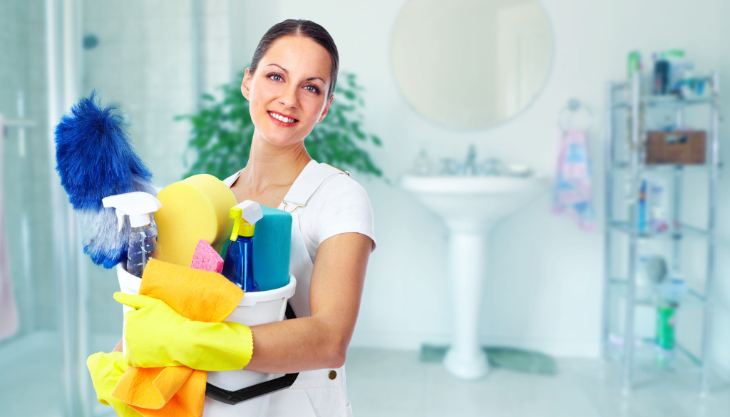 Young smiling maid. House cleaning service concept.